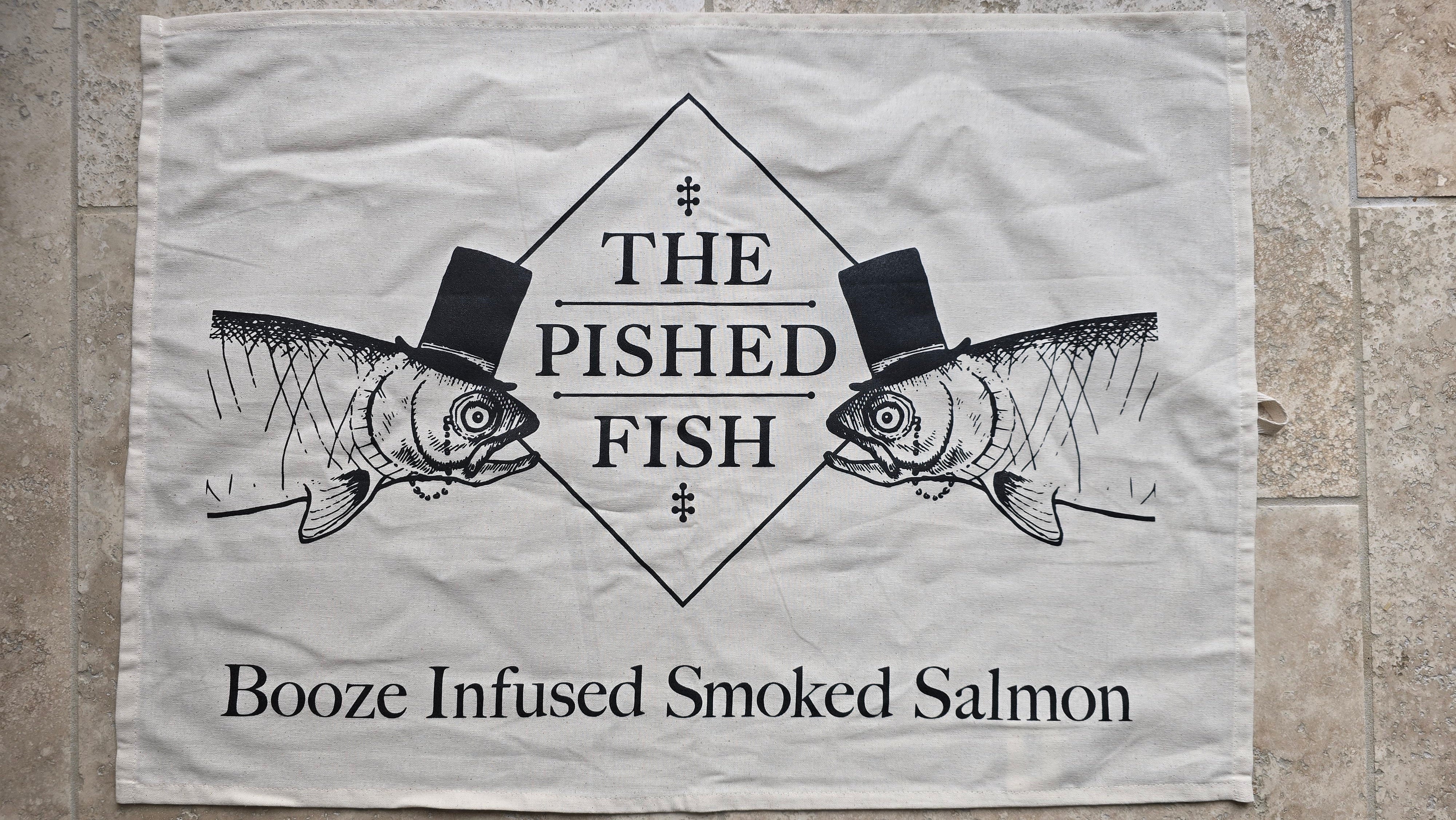 Logo of 'The Pished Fish' with two fish wearing top hats on a textured surface.