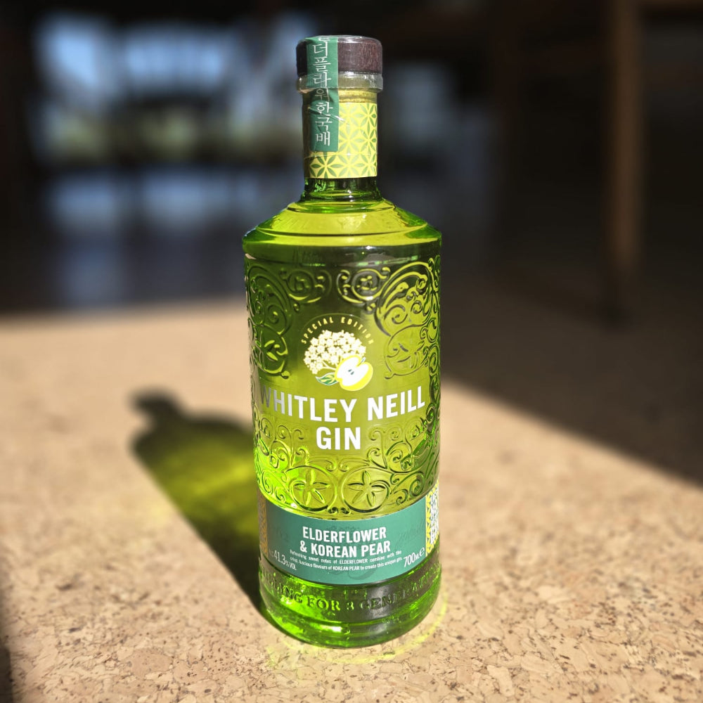 Bottle of Witley Neill Gin on a surface with a blurred background